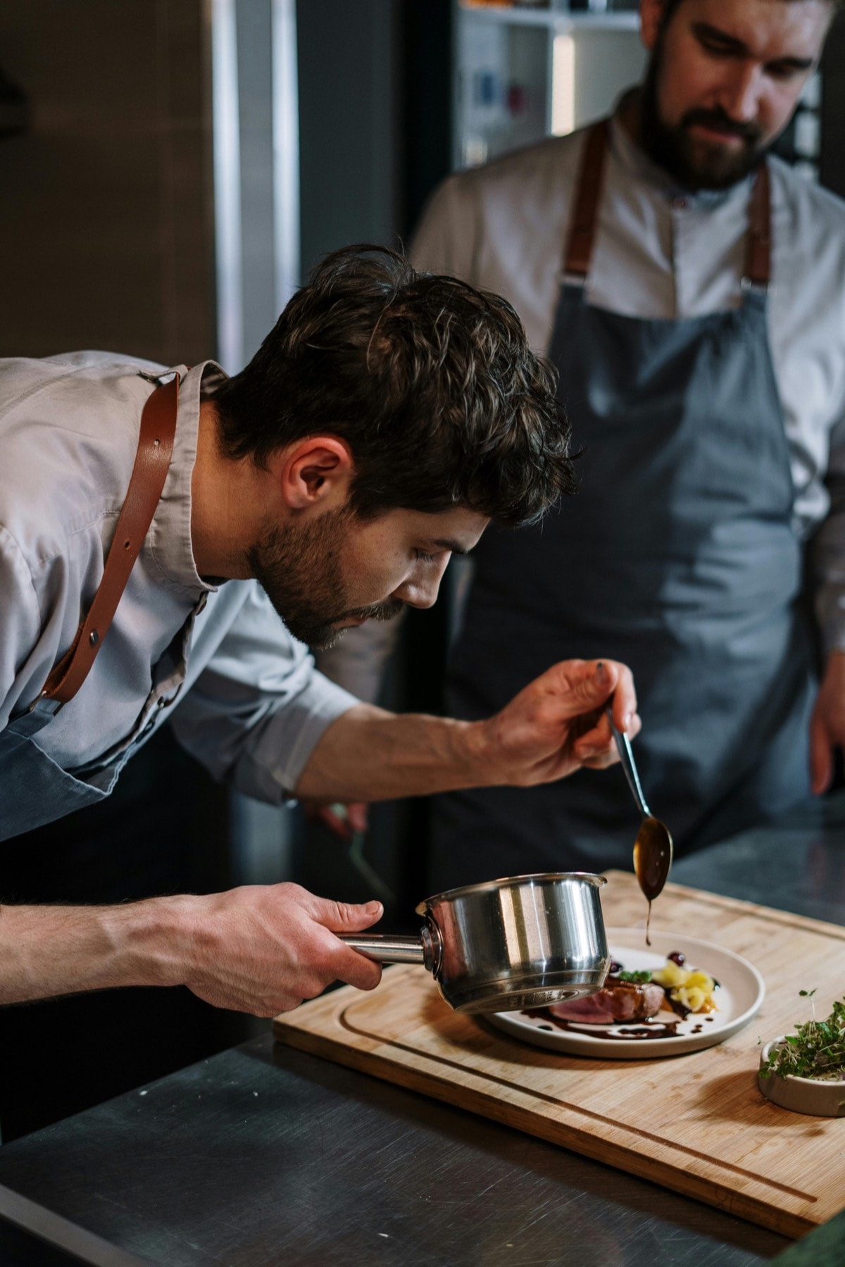 Chef plating a fine dining dish with precision